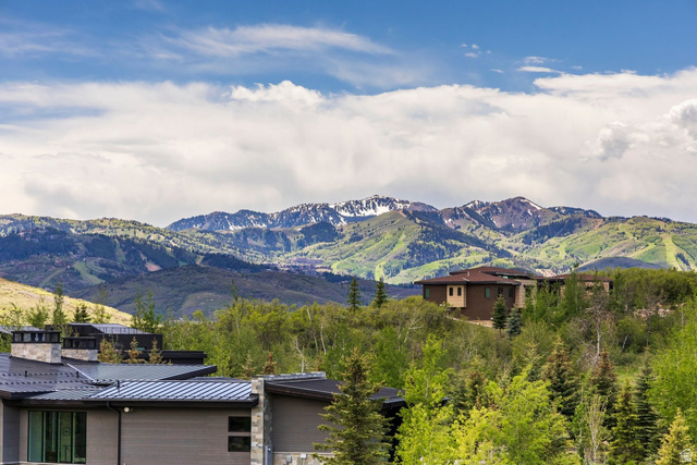 140 West Vista Road Kamas, UT 84036 - Photo 87 of 101 Contemporary exterior with a dark grey facade, a metal roof, and stone chimneys