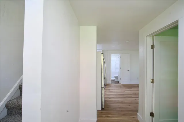 a view of a hallway with wooden floor