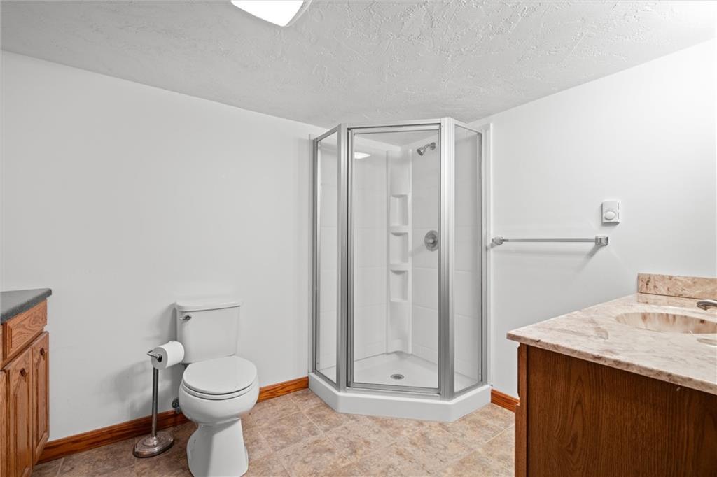 208 Republican Lane Indiana, PA 15701 - Photo 19 of 25 a bathroom with a granite countertop sink a toilet and a shower