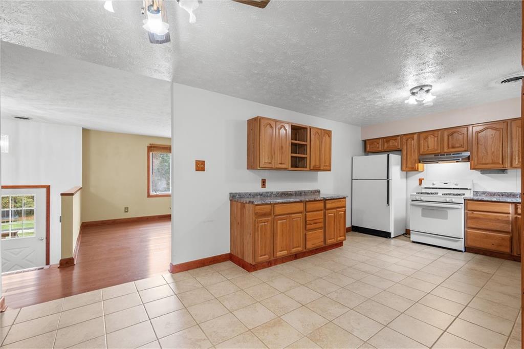 208 Republican Lane Indiana, PA 15701 - Photo 10 of 25 a large kitchen with stainless steel appliances a stove a sink and a refrigerator