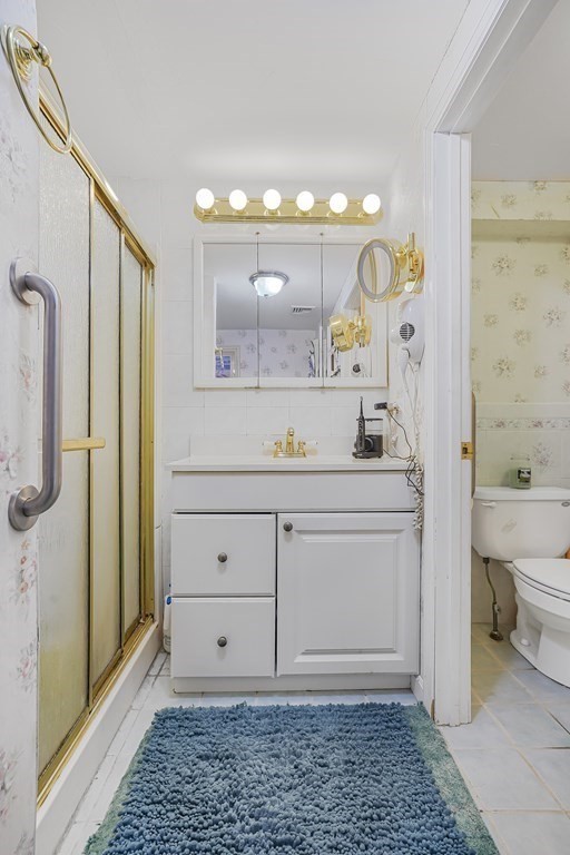 935 Almy Road Somerset, MA 02726 - Photo 23 of 37 a bathroom with a sink a toilet and shower