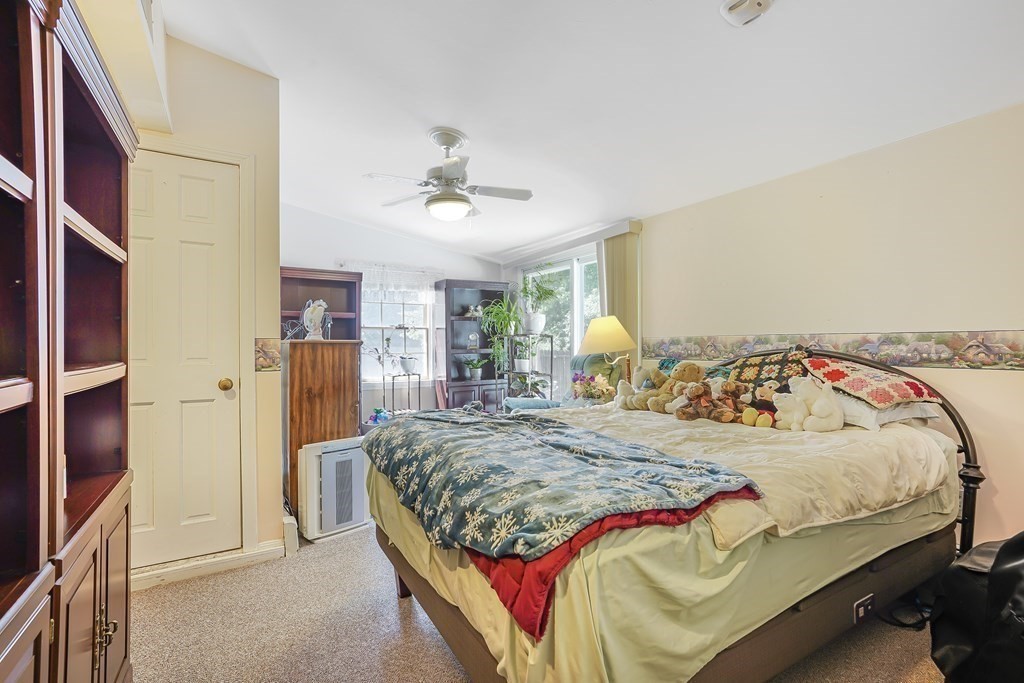 935 Almy Road Somerset, MA 02726 - Photo 25 of 37 a bedroom with a bed and a chandelier
