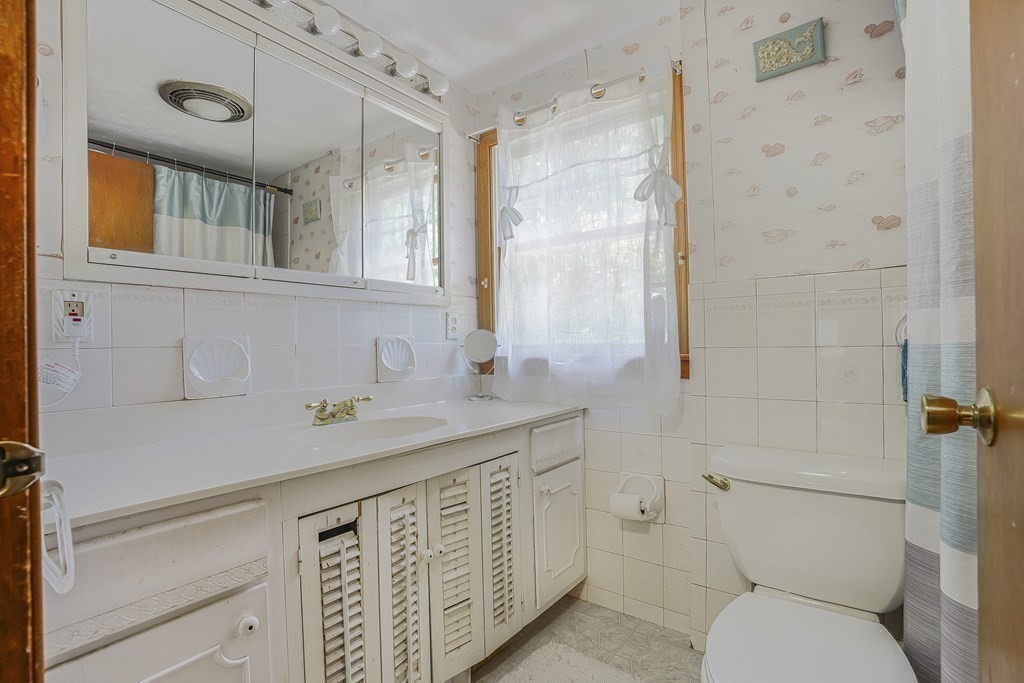 935 Almy Road Somerset, MA 02726 - Photo 30 of 37 a bathroom with a sink a toilet and shower
