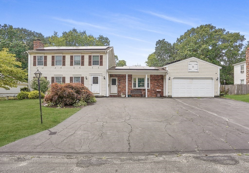 935 Almy Road Somerset, MA 02726 - Photo 3 of 37 a front view of a house with a yard and garage