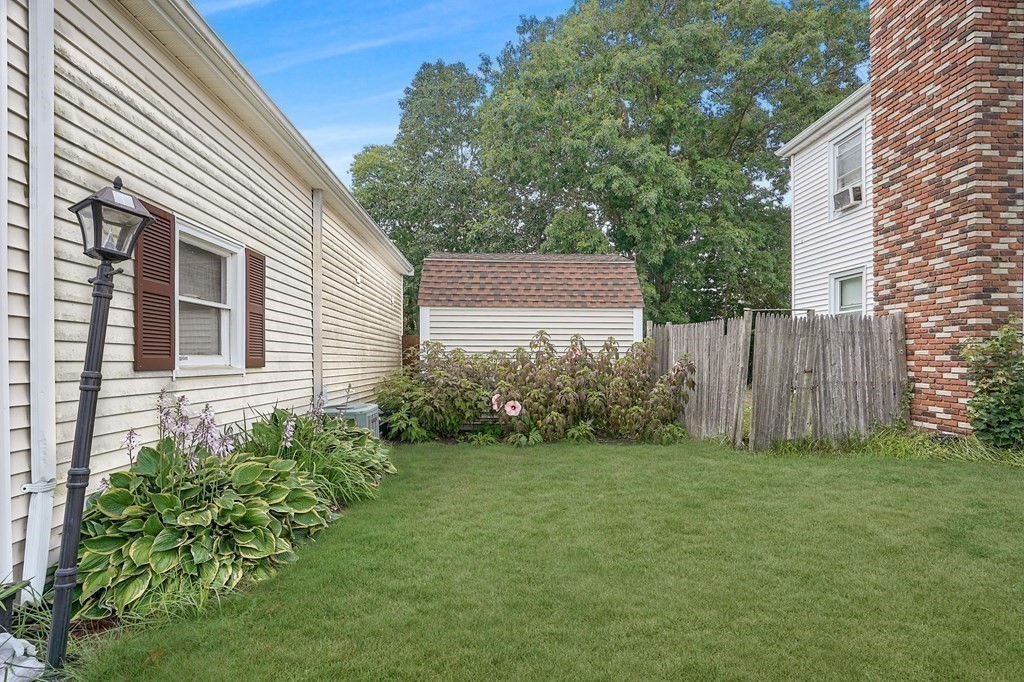 935 Almy Road Somerset, MA 02726 - Photo 4 of 37 a view of a backyard with plants and large tree