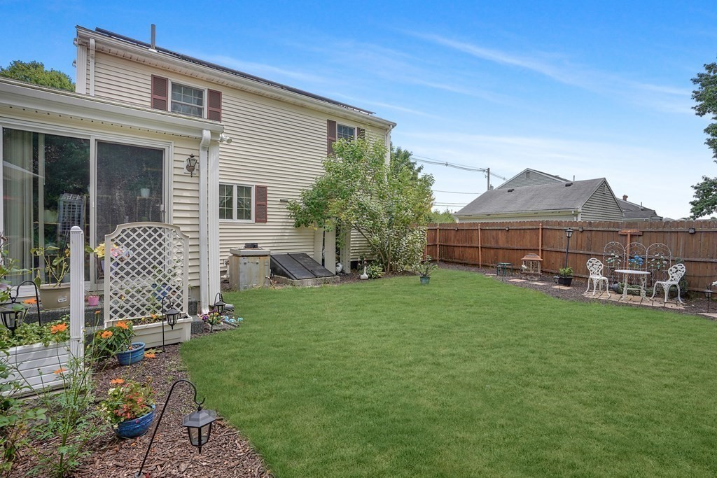 935 Almy Road Somerset, MA 02726 - Photo 6 of 37 a view of a house with backyard and a garden