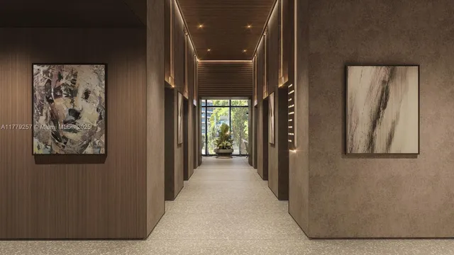 a view of a hallway with wooden floor and a bathroom