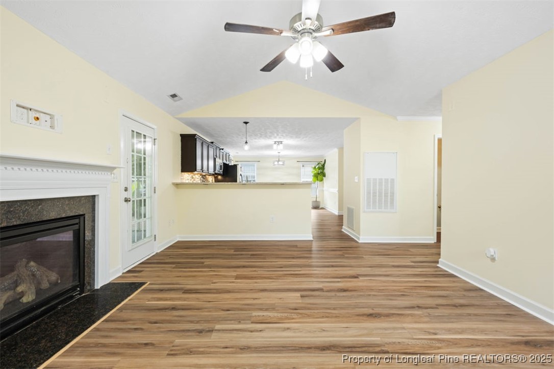 161 Bayleaf Drive Raeford, NC 28376 - Photo 11 of 33 a view of a livingroom with wooden floor and a kitchen