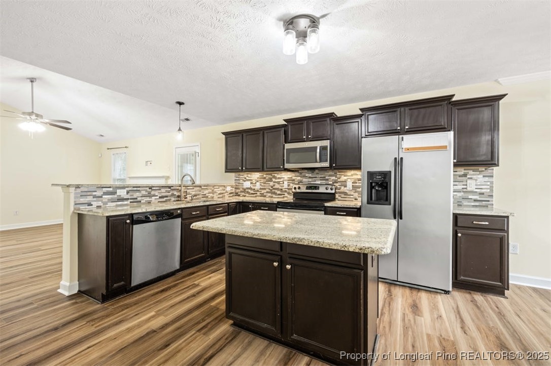 161 Bayleaf Drive Raeford, NC 28376 - Photo 13 of 33 a kitchen with stainless steel appliances granite countertop a refrigerator stove microwave and sink