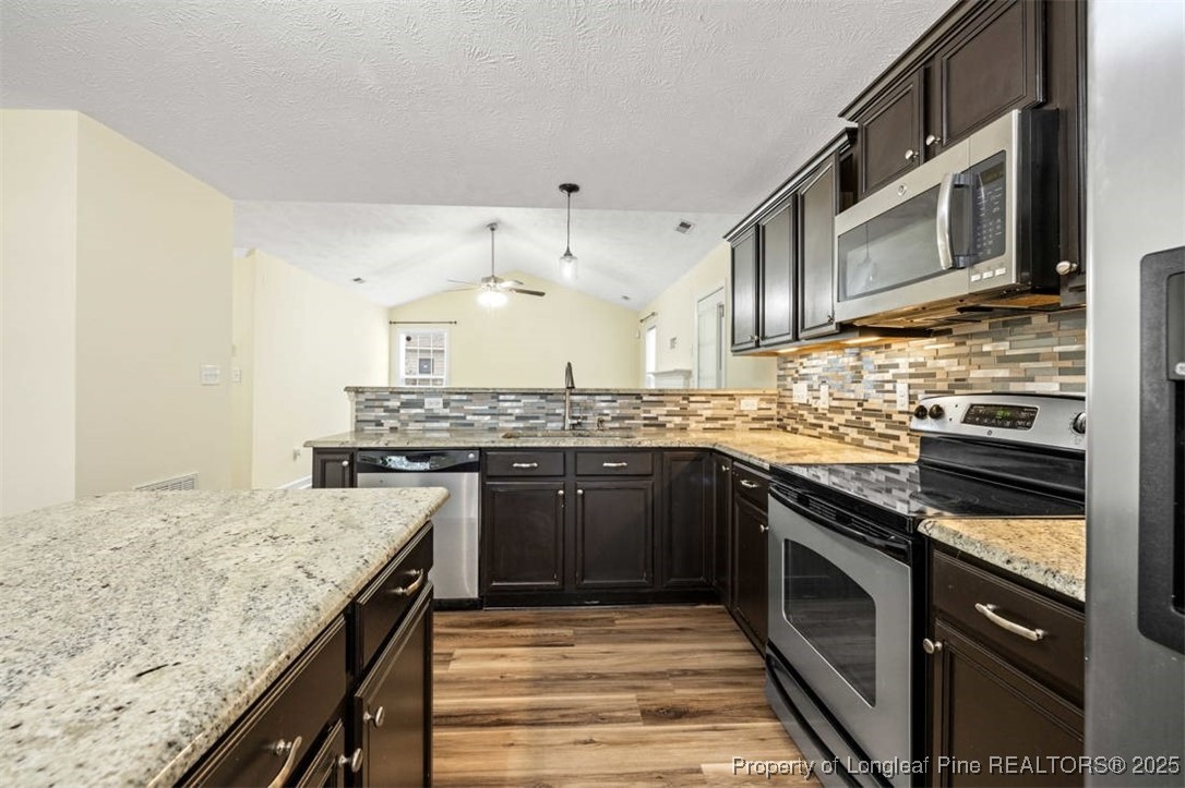 161 Bayleaf Drive Raeford, NC 28376 - Photo 15 of 33 a kitchen with stainless steel appliances granite countertop a stove sink and cabinets