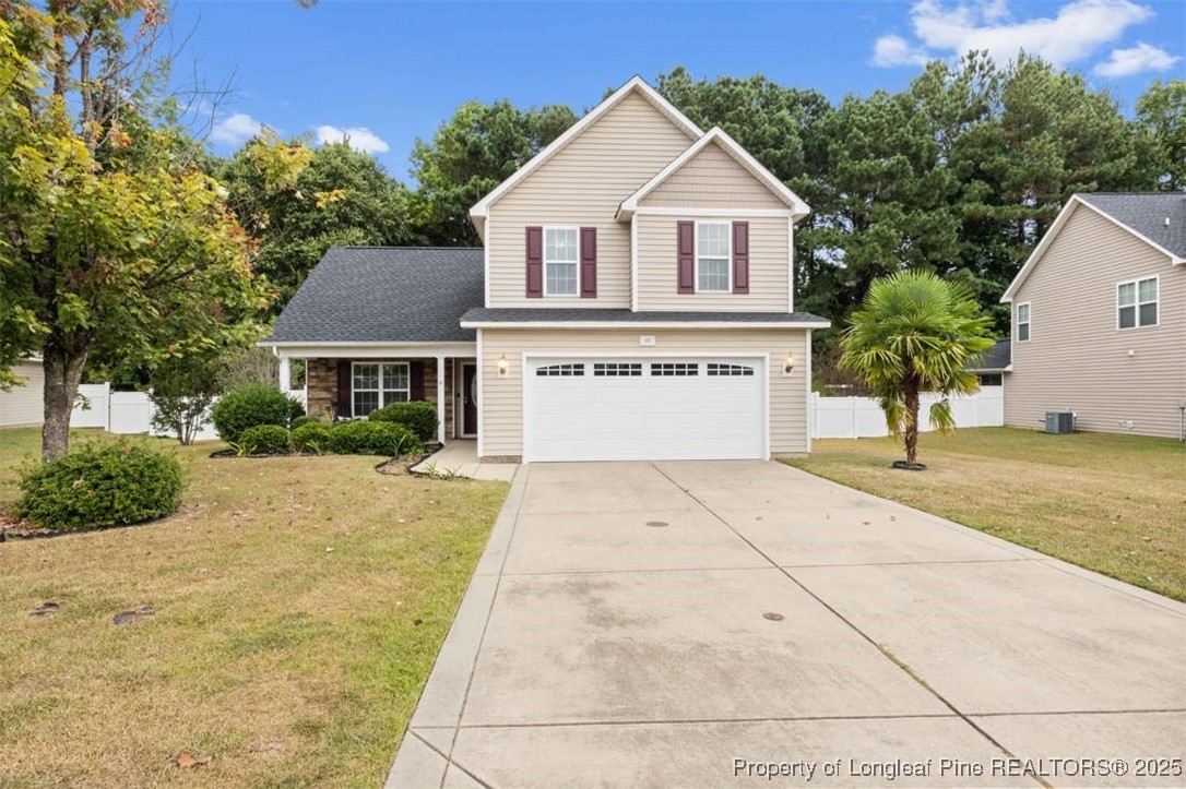 161 Bayleaf Drive Raeford, NC 28376 - Photo 2 of 33 a front view of a house with a yard and garage