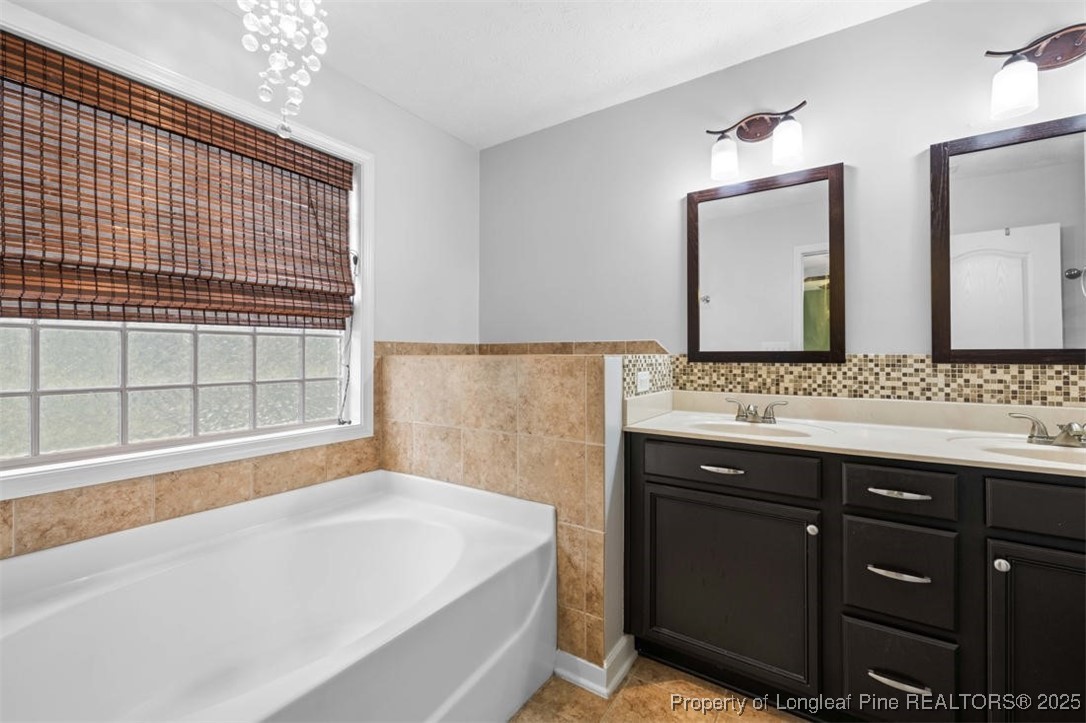 161 Bayleaf Drive Raeford, NC 28376 - Photo 21 of 33 a bathroom with a bathtub and a sink