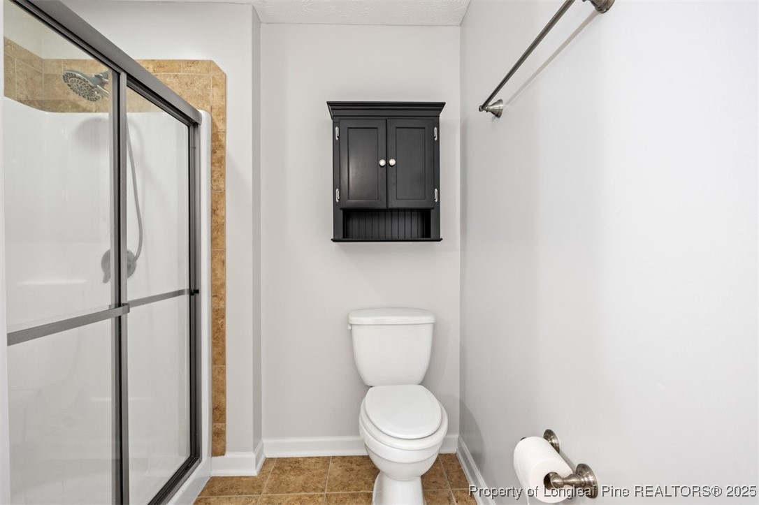 161 Bayleaf Drive Raeford, NC 28376 - Photo 23 of 33 a bathroom with a toilet and a shower