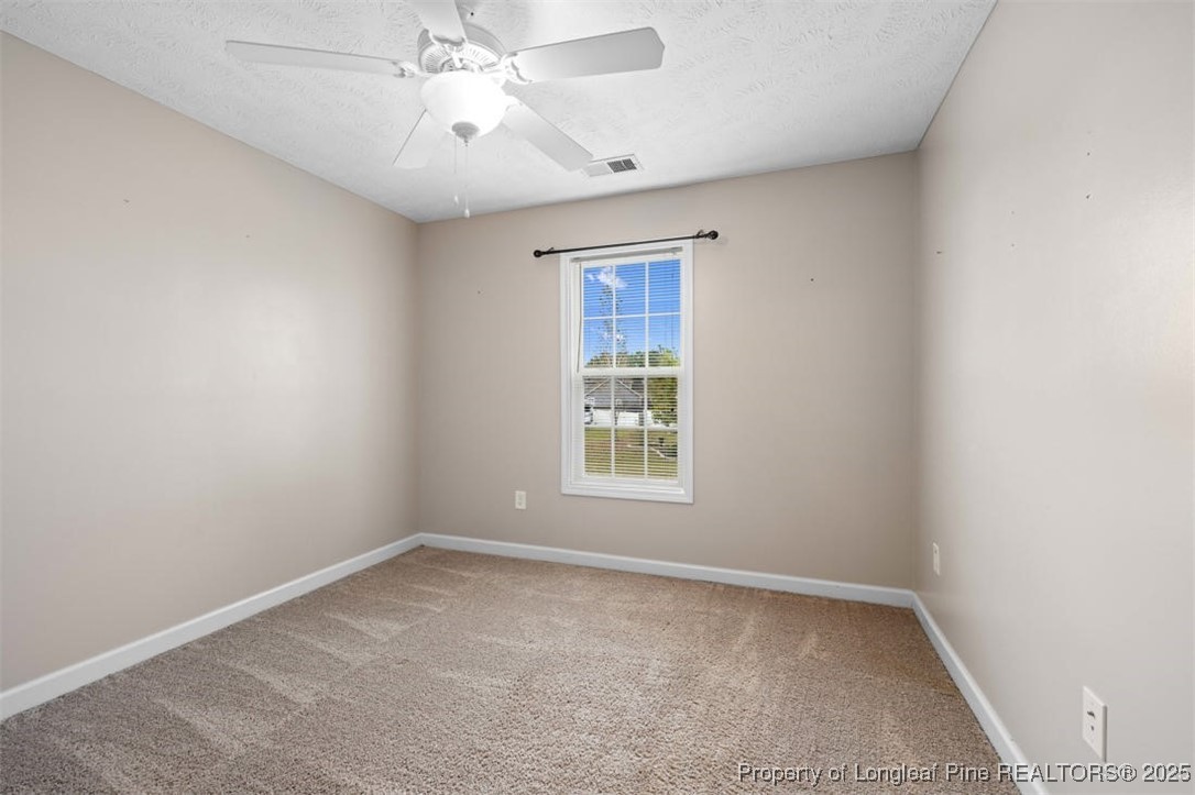 161 Bayleaf Drive Raeford, NC 28376 - Photo 26 of 33 an empty room with a window and a fan