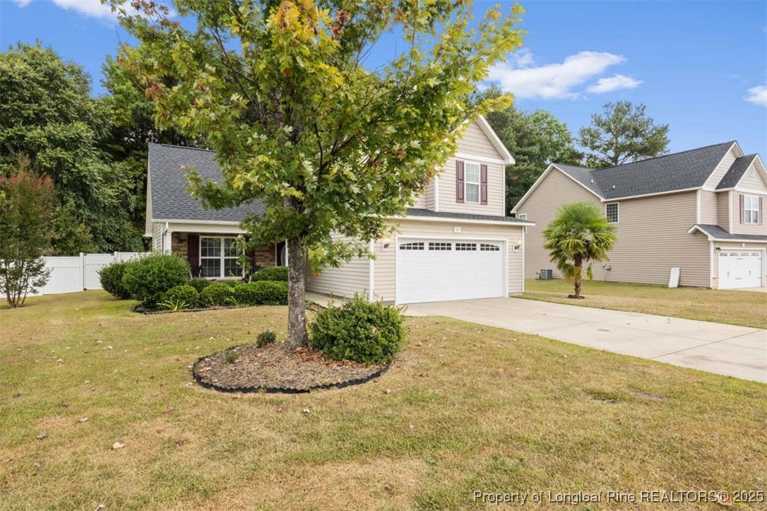 161 Bayleaf Drive Raeford, NC 28376 - Photo 4 of 33 a front view of a house with a yard and garage