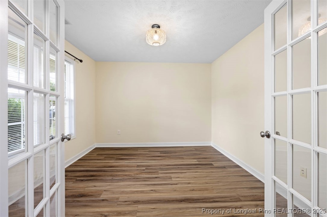 161 Bayleaf Drive Raeford, NC 28376 - Photo 8 of 33 a view of an empty room with wooden floor and a window