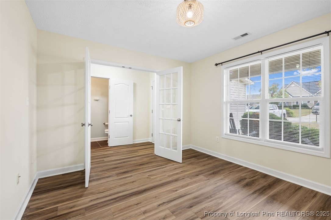 161 Bayleaf Drive Raeford, NC 28376 - Photo 9 of 33 a view of an empty room with wooden floor and a window