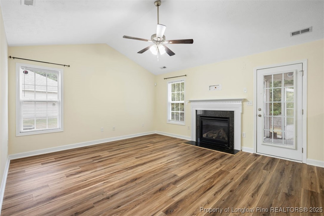 161 Bayleaf Drive Raeford, NC 28376 - Photo 10 of 33 a view of empty room with wooden floor fireplace and a window