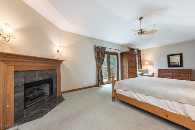 3700 Glendenning Road Downers Grove, IL 60515 - Photo 13 of 25 a bedroom with a bed and a fireplace