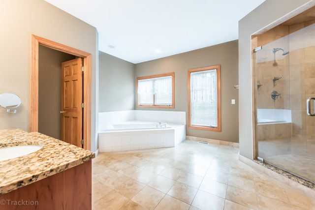3700 Glendenning Road Downers Grove, IL 60515 - Photo 14 of 25 a spacious bathroom with a granite countertop sink and a mirror