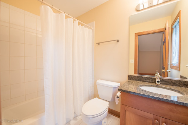 3700 Glendenning Road Downers Grove, IL 60515 - Photo 20 of 25 a bathroom with a granite countertop sink toilet and a mirror