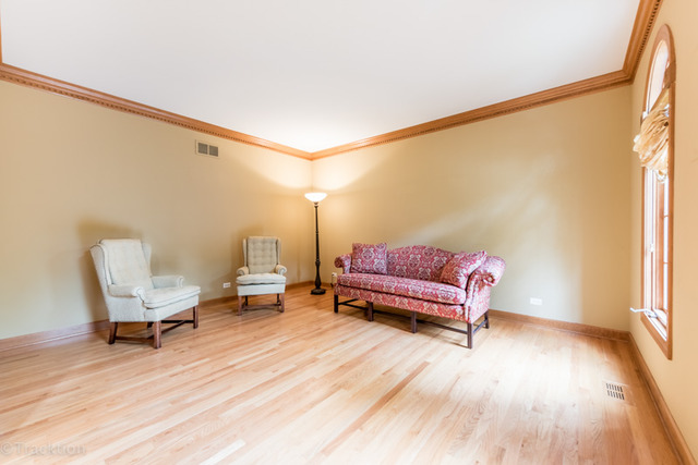 3700 Glendenning Road Downers Grove, IL 60515 - Photo 4 of 25 a living room with a couch and a wooden floor
