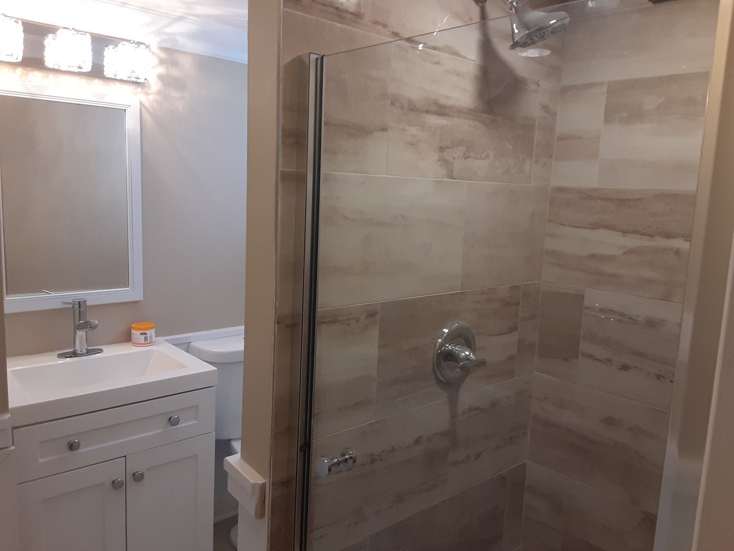 1417 Lee Boulevard Berkeley, IL 60163 - Photo 17 of 24 a bathroom with a shower a sink and vanity