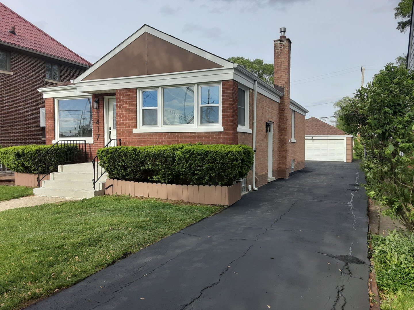 1417 Lee Boulevard Berkeley, IL 60163 - Photo 2 of 24 a front view of a house with a yard and potted plants