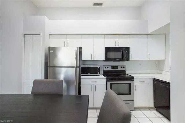 a kitchen with a sink stainless steel appliances and cabinets