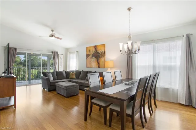 a living room with furniture a table and a chandelier