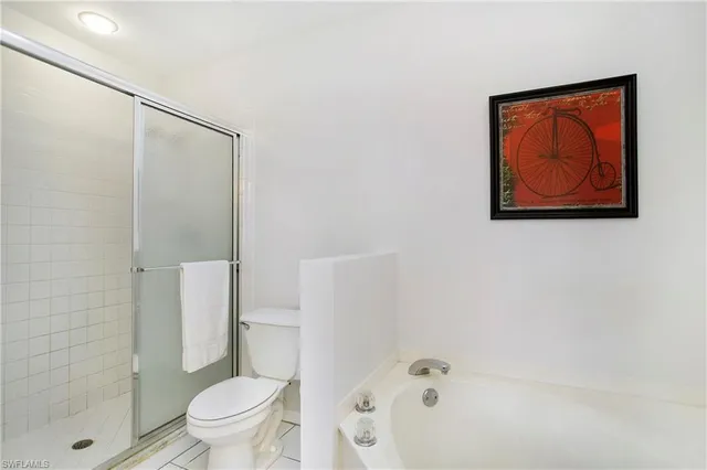 a white toilet sitting next to a bath tub shower
