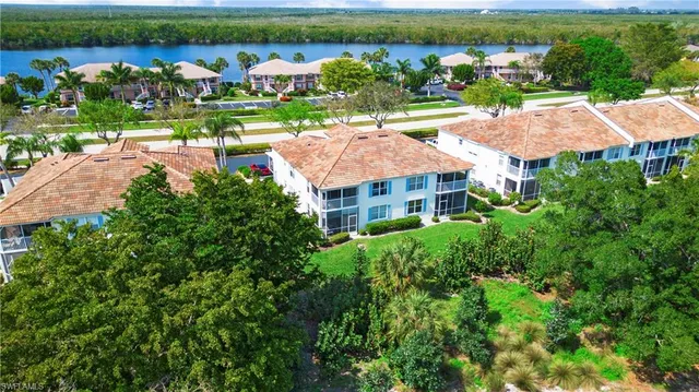 an aerial view of a house with a garden and lake view