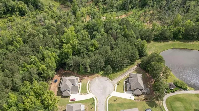 an aerial view of a house with swimming pool and garden view