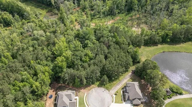an aerial view of a house with a yard and lake view