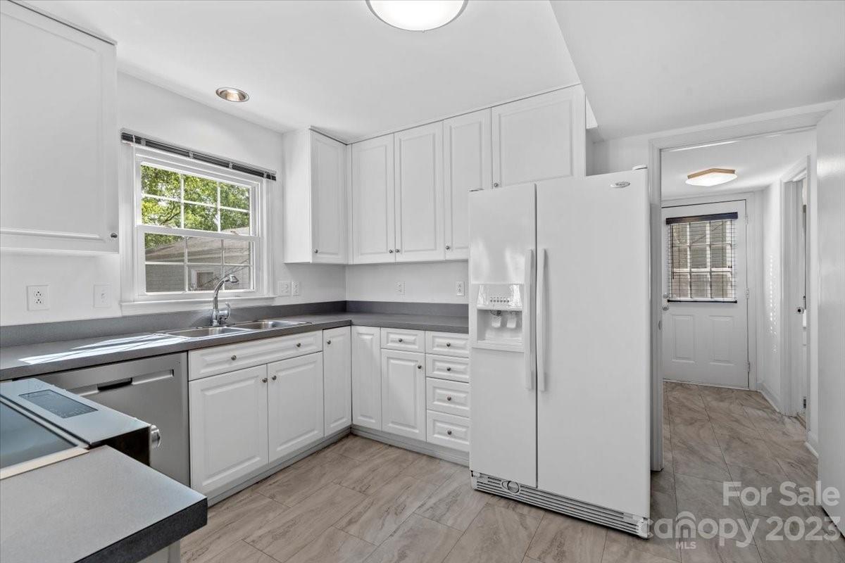 12112 Painted Tree Road Charlotte, NC 28226 - Photo 11 of 41 a kitchen with white cabinets and white appliances