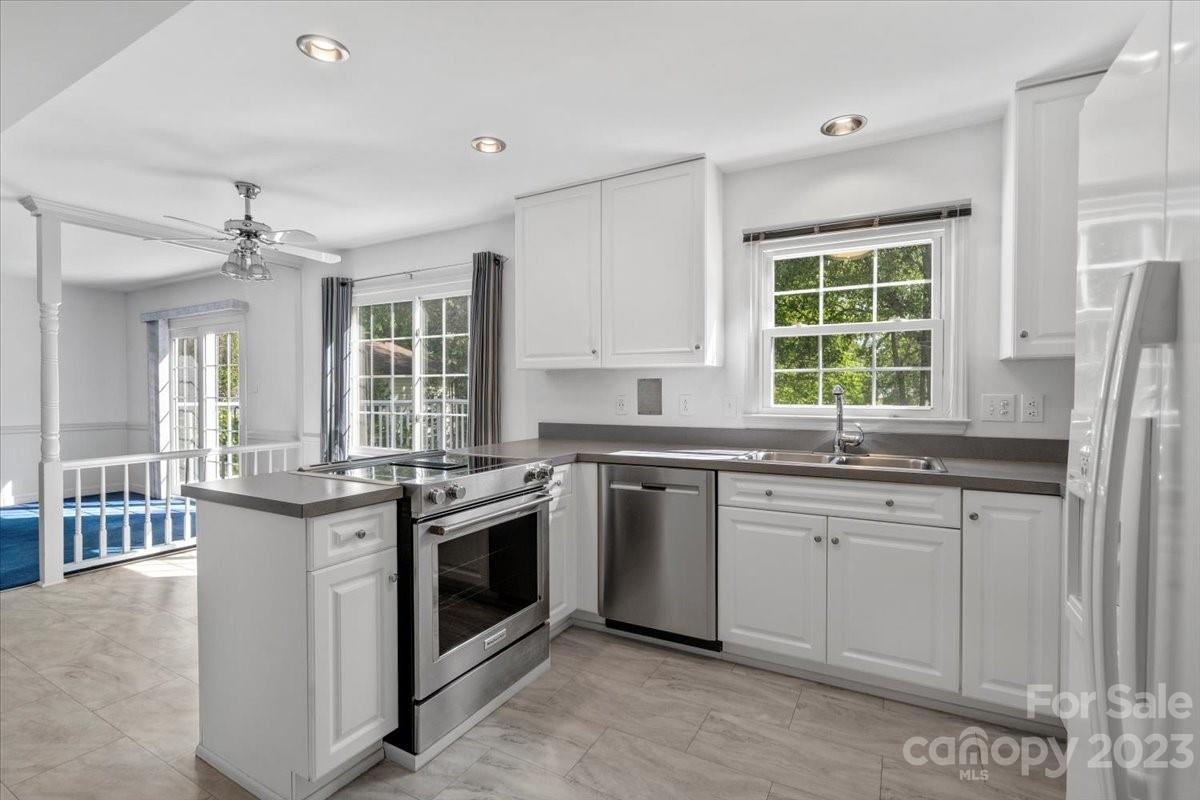 12112 Painted Tree Road Charlotte, NC 28226 - Photo 12 of 41 a kitchen with stainless steel appliances granite countertop a stove and a sink