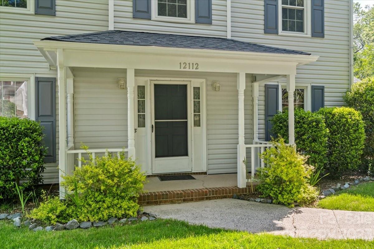 12112 Painted Tree Road Charlotte, NC 28226 - Photo 2 of 41 a view of a house with potted plants and a yard with potted plants