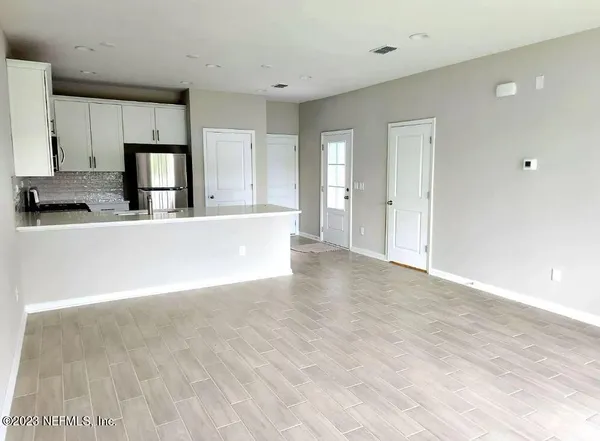 a view of a kitchen with a sink cabinets and wooden floor