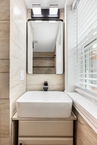 a bathroom with a sink and a mirror