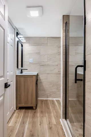 a bathroom with a sink a mirror and shower