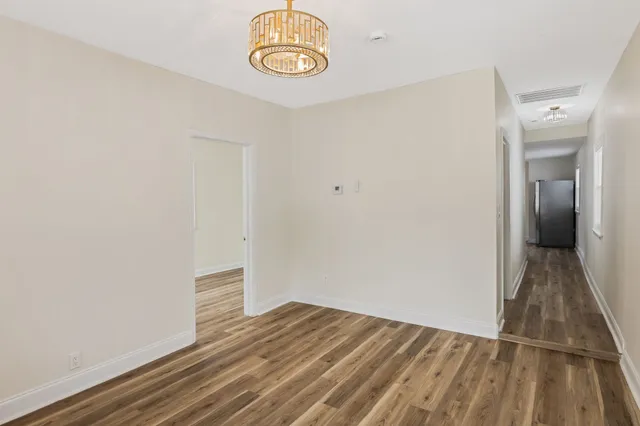 a view of a room with wooden floor