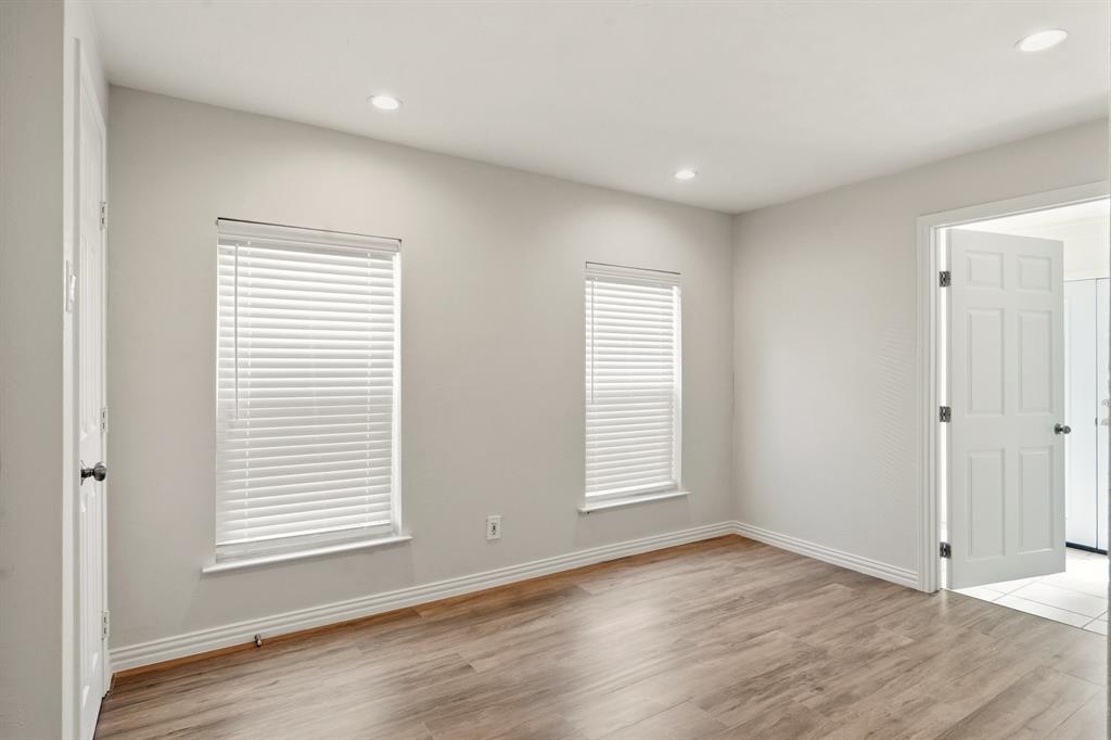 7354 Walling Lane Dallas, TX 75231 - Photo 16 of 28 an empty room with wooden floor and windows