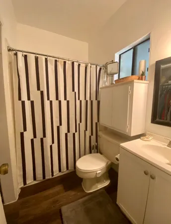 a bathroom with a sink toilet and shower