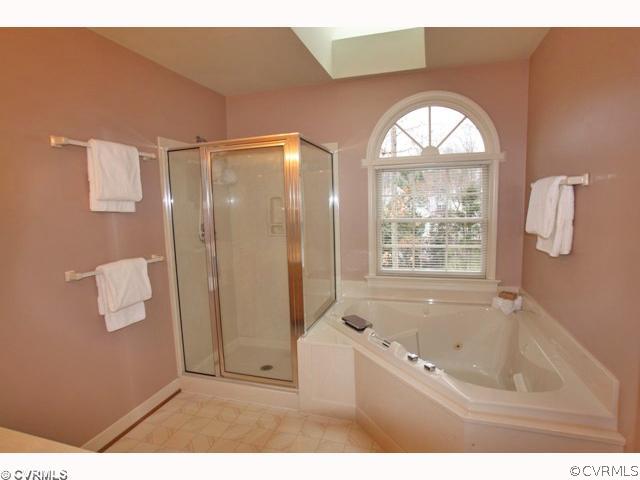 15203 Powell Grove Road Midlothian, VA 23112 - Photo 11 of 12 a bathroom with a bathtub a shower and a sink