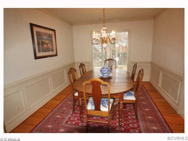 15203 Powell Grove Road Midlothian, VA 23112 - Photo 3 of 12 a view of a dining room with furniture and chandelier
