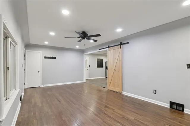 a view of an empty room with wooden floor