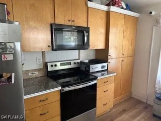 a kitchen with a stove and a microwave