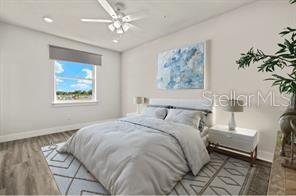 14989 Sunset Eve Loop Fort Myers, FL 33919 - Photo 2 of 9 a bedroom with a large bed and a chandelier