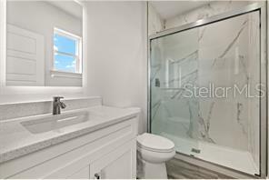 14989 Sunset Eve Loop Fort Myers, FL 33919 - Photo 5 of 9 a bathroom with a sink and a mirror