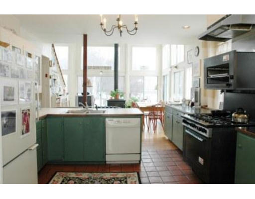 106 Elm Street Concord, MA 01742 - Photo 11 of 15 a kitchen with sink a stove and chairs